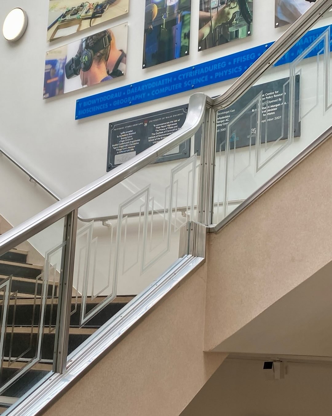 Acid etched glass stair balustrade panels in a university building