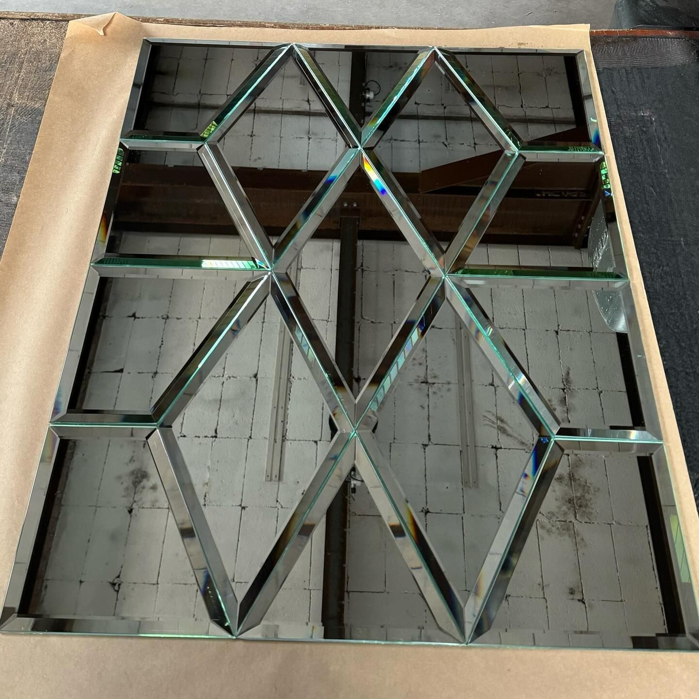 Bevelled glass lattice laid out on the bench