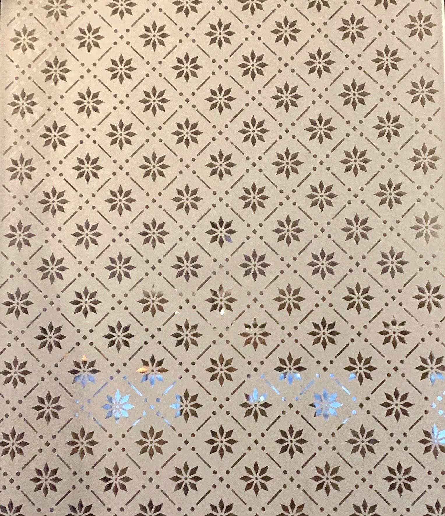Frosted glass panel with a repeating star and flower pattern