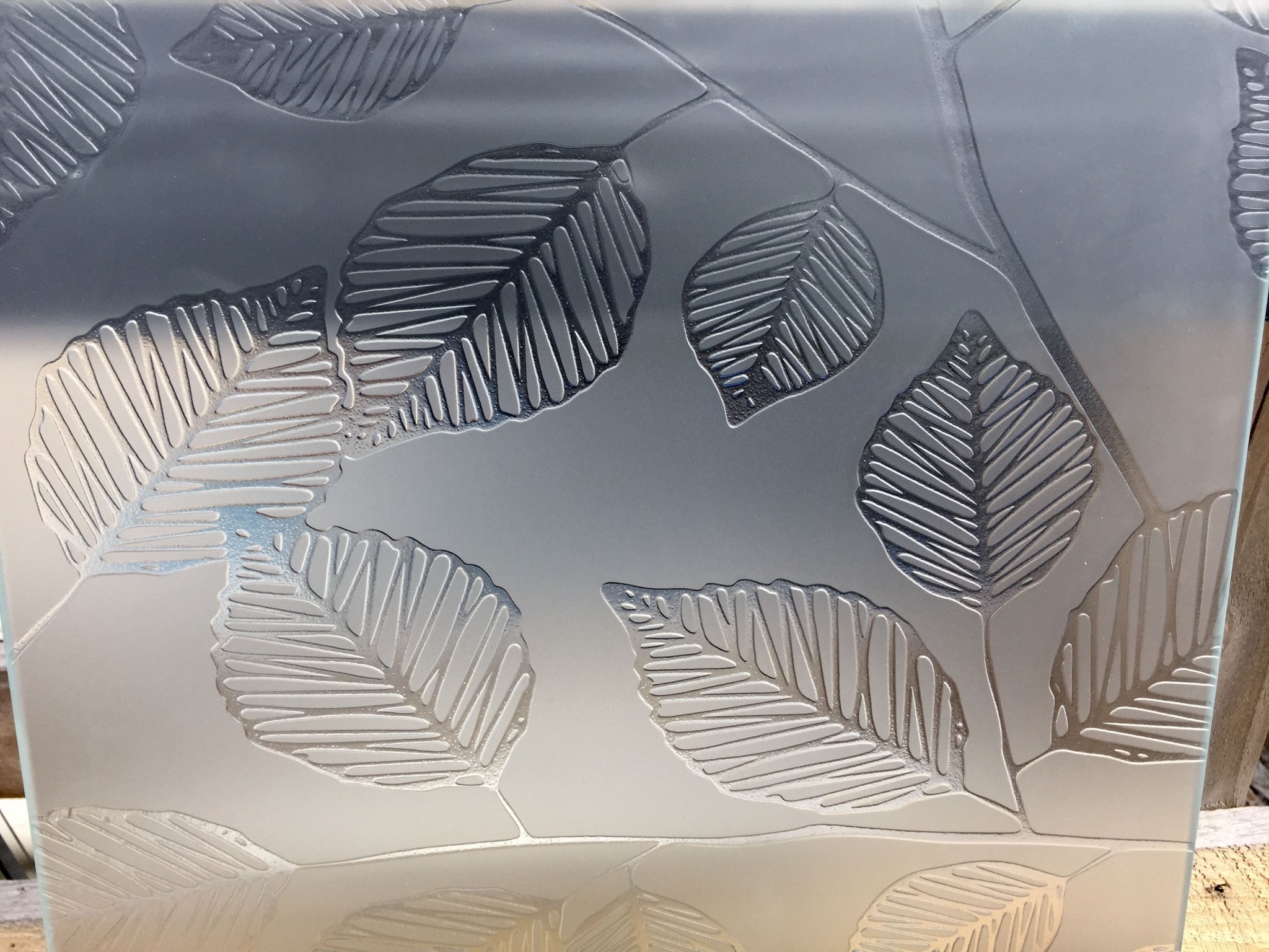 Sand carved glass with leaves in deep relief