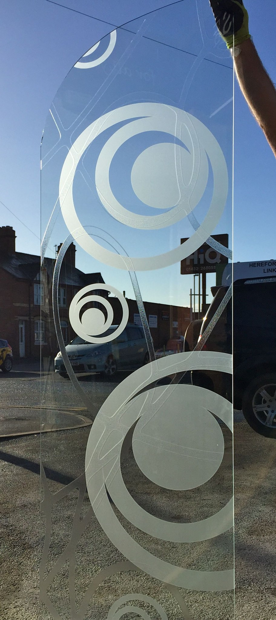 Tall glass panel with sandblasted circles