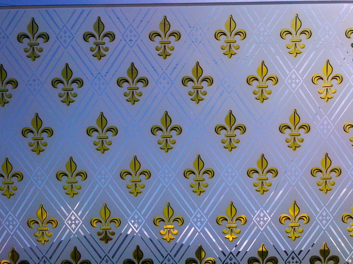 Gold fleur-de-lis printed on blue colour coated glass