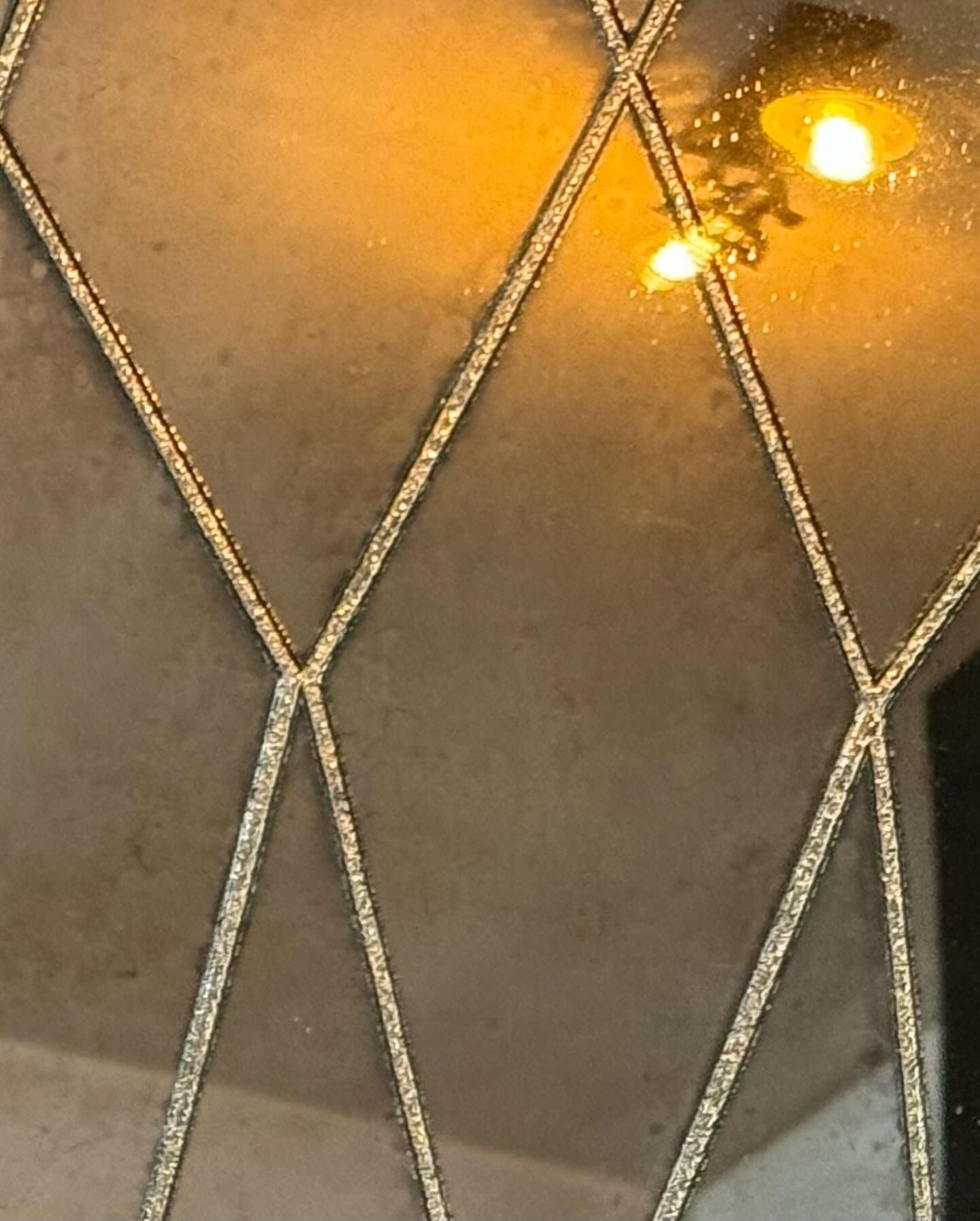 Close detail of an acid etched, aged convex mirror