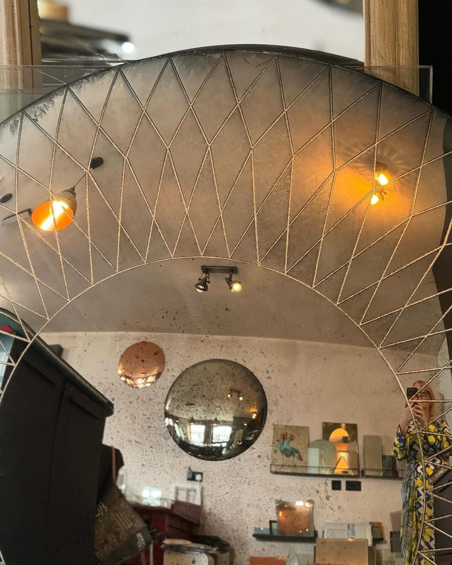 Large acid etched, hand-antiqued convex mirror reflecting a room