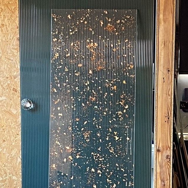 Reeded glass panel with a gold leaf fleck finish
